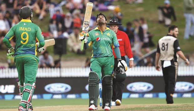 Umar Akmal of Pakistan (C) celebrates his half-century during the second Twenty20 match against New Zealand at Seddon Park in Hamilton yesterday. (AFP)