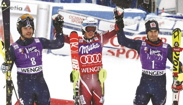 Henrik Kristoffersen of Norway is flanked by Italyu2019s 2nd placed Giuliano Razzoli (L) and 3rd placed compatriot Stefano Gross after their Alpine Skiing World Cup slalom in Wengen, Switzerland, yetserday.