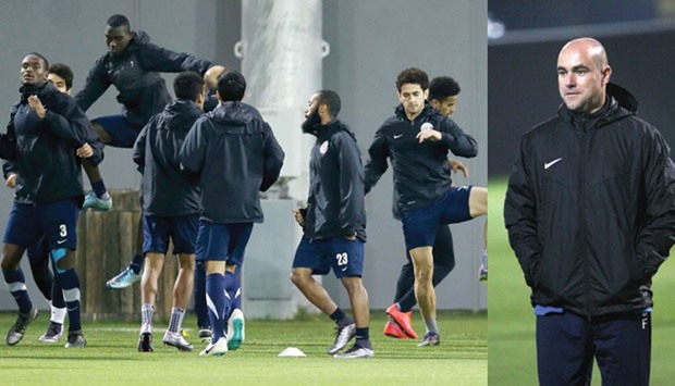 Qatar coach Felix Sanchez watches his team train on the eve of their match against Syria.