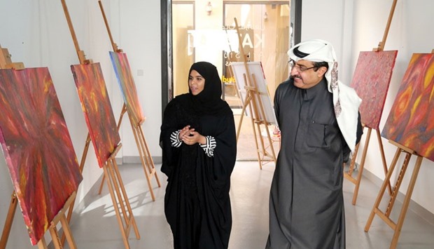 Katarau2019s Darwish Ahmed al-Shibani touring the exhibition with Qatari artist Aisha al-Kaabi.