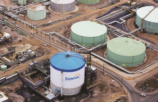 Petroleum storage tanks at the Suncor tar sands operations near Fort McMurray, Alberta. Suncor wants the Canadian Oil Sands deal because it would increase the companyu2019s stake in the Syncrude Canada oil-sands mine and upgrader to 49% from 12%, making it the largest shareholder.