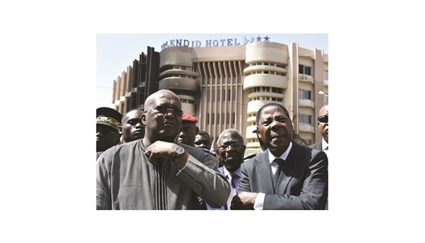 Burkina Fasou2019s President Roch Marc Christian Kabore (left) and Beninu2019s President Thomas Boni Yayi visit the Splendid hotel and the Capuccino cafe in Ouagadougou.