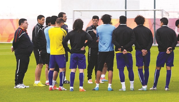 Iraq coach Shahad Abdulghani (centre) talks to his players during a training session. The result of the match between Iraq and South Korea will decide who tops Group C.