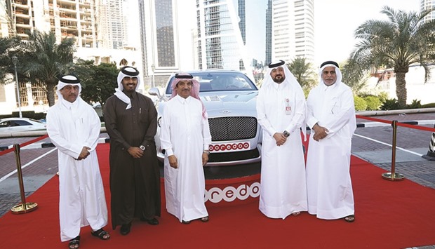 Officials pose in front of a Bentley car that would be awarded as one of the prizes at the races. Inset: HE Sheikh Hamad bin Jassim bin Faisal al-Thani.