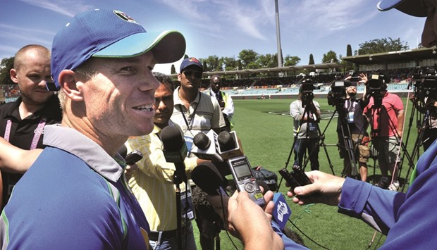 David Warner of Australia (L) speaks to the media as he takes part in a team training session at the Manuka Oval in Canberra yesterday ahead of the fourth one-day international against India. (AFP)