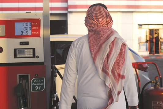 A Saudi man walks past a pump at a petrol station in Jeddah. Saudi oil demand is forecast to rise by just 45,000 bpd to 3.3mn bpd in 2016, sharply lower than the 125,000-bpd gain in 2015, the IEA said.