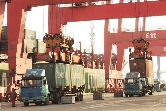 Containers are being transported at a port in Lianyungang, eastern Chinau2019s Jiangsu province yesterday. Chinau2019s GDP grew at its slowest in a quarter of a century last year, creating pressure for more stimulus policies to ensure a soft landing for the economy that is a crucial driver of global growth.