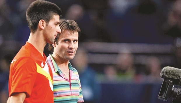 An Italian newspaper has alleged that Novak Djokovic (left) deliberately lost a match to Frenchman Fabrice Santoro at the 2007 Paris Masters.