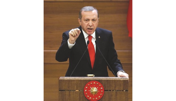 Erdogan delivering a speech during the Mukhtars (Mayors) meeting yesterday at the Presidential Complex in Ankara. He launched a blistering attack yesterday on academics who criticised his policies in the Kurdish-dominated southeast, warning that they would pay a price after falling into a u2018pit of treacheryu2019.