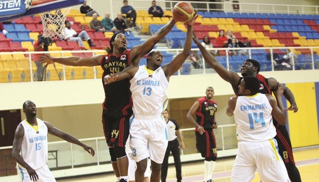 Al Rayyanu2019s Alexander Immanuel (left) and Tanguy Ngombo vie for the ball with Al Gharafau2019s Kevin Galloway (second from left) during their Qatar Basketball League match yesterday. PICTURES: Nasar T