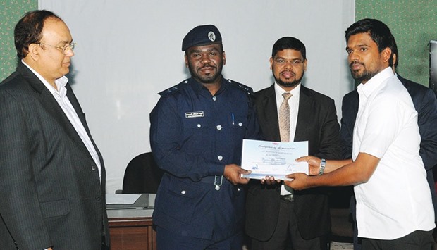 An MoI official giving a certificate to a participant.