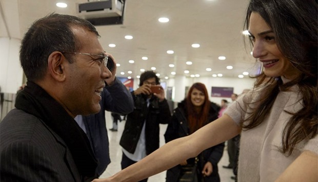 Former Maldives president Mohamed Nasheed (L) is greeted by British lawyer Amal Clooney on his arrival at Heathrow airport in London today. AFP