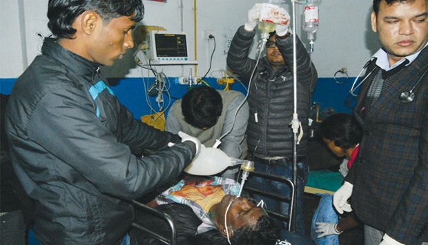 Nepalese doctors treat a protestor who was injured during a demonstration in Biratnagar