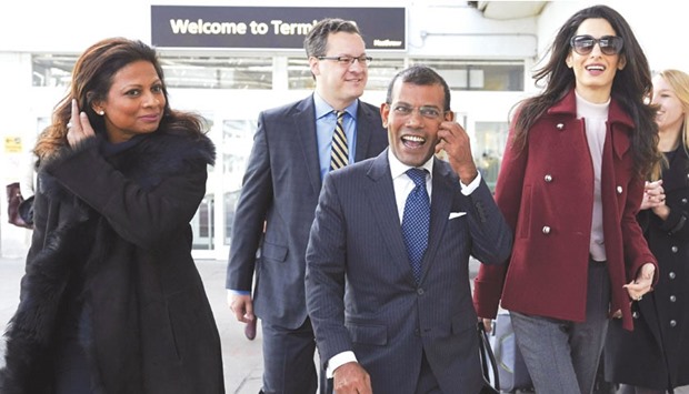 Laila Ali, wife of Mohamed Nasheed, former Maldives president Mohamed Nasheed and British lawyer Amal Clooney smile after Nasheed arrived at Heathrow airport in London.