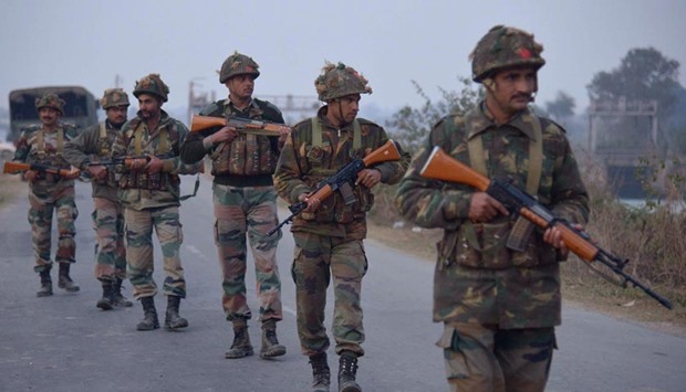 Indian Army personnel patrol near the Air Force base in Pathankot on Saturday.