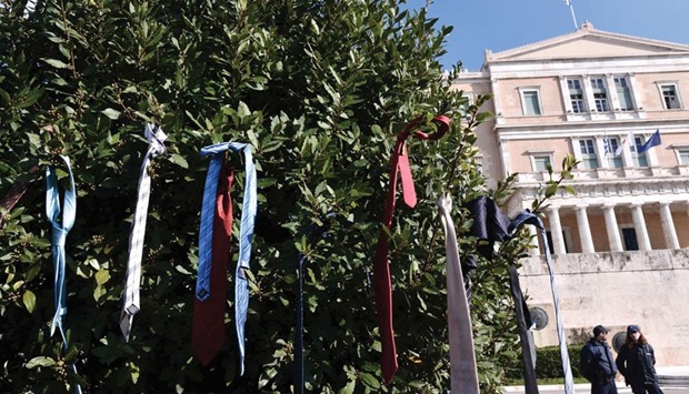 Lawyersu2019 ties are left hanging on a bush in front of the Greek parliament in Athens during a massive rally yesterday against the social security reforms proposed by the government. Thousands of scientists, doctors, lawyers, engineers and self-employed professionals participated in a rally to protest the governmentu2019s draft bill regarding reforms in the countryu2019s pension system.