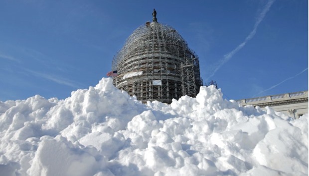 A pile of shovelled snow stands in the plaza on the east side of the US Capitol yesterday in Washington, DC. One inch of snowfall delayed school openings in the greater Washington, DC, area yesterday as people along the Easter Seaboard prepare for a blizzard to arrive within the next 24 hours.