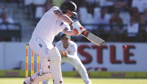 Englandu2019s batsman Benjamin Stokes (C) plays a shot during the day one of the second Test against South Africa at Newlands stadium in Cape Town yesterday. (AFP)