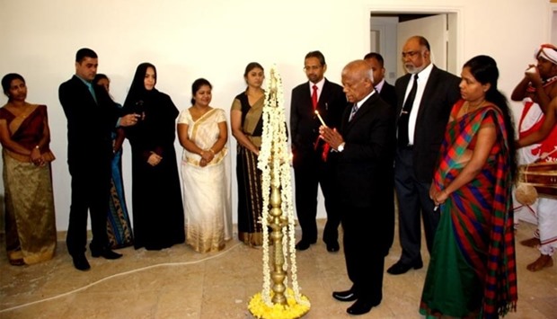 Sri Lankan ambassador Prof (Dr) W M Karunadasa lighting the traditional lamp.