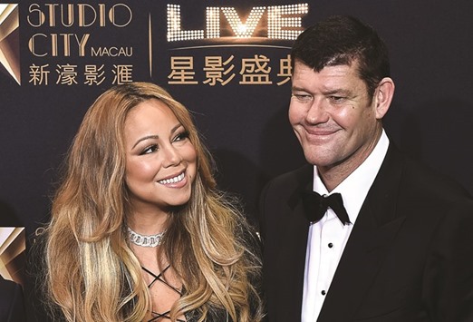 File photo shows US singer Mariah Carey (left) looking at co-chairman of Melco Crown Entertainment, James Packer, as they stand on the red carpet ahead of the opening ceremony of the Studio City casino resort in Macau.