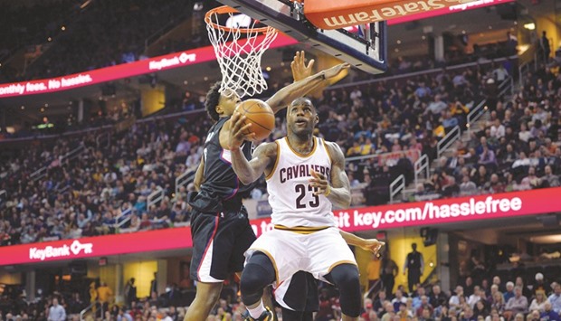 Cleveland Cavaliers forward LeBron James (No 23) puts a reverse layup against the Los Angeles Clippers in the third quarter at Quicken Loans Arena. PICTURE: USA TODAY Sports