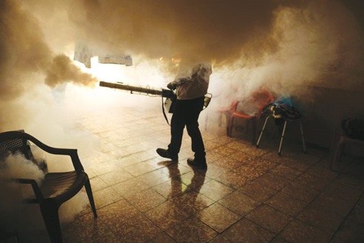A Health Ministry employee fumigates a home against the Aedes aegypti mosquito to prevent the spread of the Zika virus in Soyapango, 6km east of San Salvador, on Thursday.