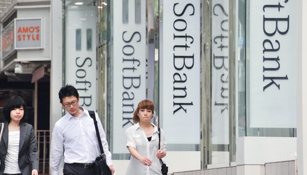 Pedestrians pass before a SoftBank mobile phone shop in Tokyo. The Japanese firm tumbled below the value of its stake in Alibaba amid growing concerns about the companyu2019s other assets, including struggling US wireless carrier Sprint.