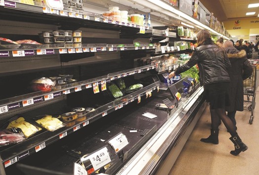 Shelves in the produce section at a supermarket start to empty ahead of an expected blizzard in Washington, DC.