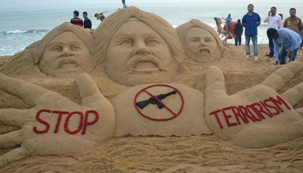 Sand artist Sudarsan Pattnaik makes a sand sculpture condemning the attack on the Pathankot air base, with the message u201cstop terrorismu201d at Puri beach, about 65 kilometres from Bhubaneswar.