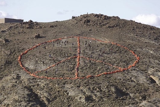 Volunteers from various non-governmental organisations (NGO) arrange more than 2,500 discarded lifejackets, used by refugees and migrants, in the shape of the peace symbol on the Greek island of Lesbos.