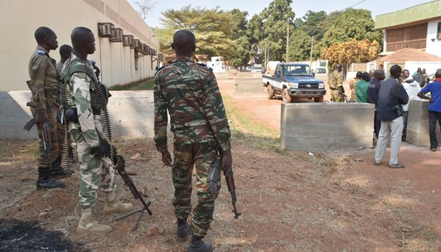 Central African Republic gendarmes and police officers stand guard outside a vote-counting centre for the presidential and parliamentary elections yesterday in Bangui.