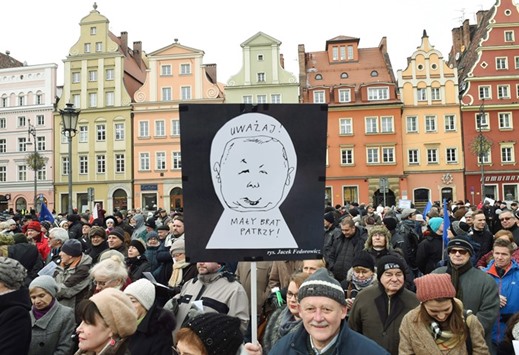 Supporters of the Committee for the Defence of Democracy (KOD) movement hold a poster with a cartoon of the leader of the PiS, Jaroslaw Kaczynski, and inscription u2018watch out, the little brother is watching youu2019 during a protest against the conservative government in Wroclaw yesterday.
