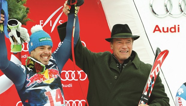 First placed Peter Fill (L) of Italy poses with actor Arnold Schwarzenegger as he celebrates after winning the menu2019s Alpine Skiing World Cup downhill race in Kitzbuehel, Austria, yesterday.  (Reuters)