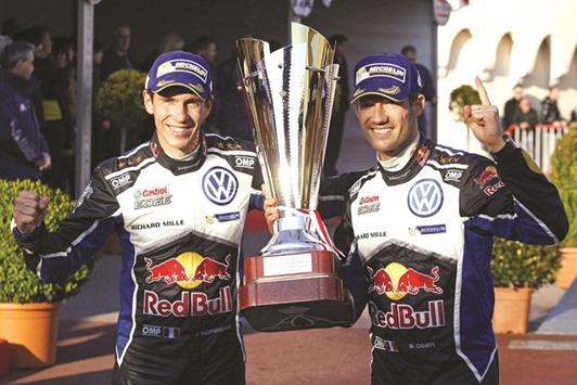 French driver Sebastien Ogier (right) and co-driver Julien Ingrassia pose with the trophy after winning the 84th Monte-Carlo Rallye, in Monaco yesterday. Ogier took the first leg of the World Rally Championship almost two minutes clear of his Norwegian teammate Andreas Mikkelsen with Belgian Thierry Neville in a Hyundai coming third. (AFP)