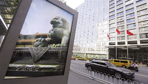 An advertising board shows a Chinese stone lion pictured near an entrance to the headquarters of China Securities Regulatory Commission in Beijing. The Chinese stock market rout this month hasnu2019t slowed the volume of foreign acquisitions, which has already reached one-third of last yearu2019s record tally, according to data compiled by Bloomberg.