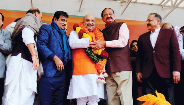 Federal ministers and BJP leaders Rajnath Singh, Nitin Gadkari and Venkaiah Naidu congratulate Amit Shah after he was re-elected BJP president in New Delhi yesterday.