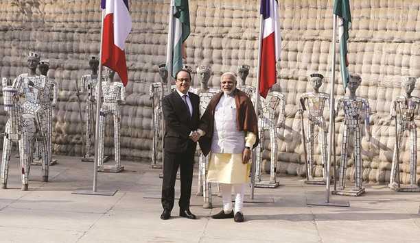 French President Francois Hollande shakes hands with Prime Minister Narendra Modi during their visit to the Rock Garden in Chandigarh yesterday.
