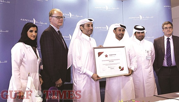 Aspetar officials with the accreditation plaque