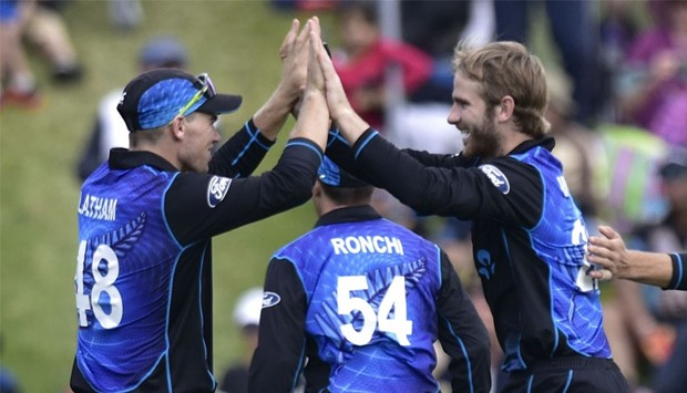Kane Williamson (R) captain of New Zealand celebrates Mohammad Hafeez of Pakistan being caught with teammate Tom Latham during the first one-day international between New Zealand and Pakistan at the Basin Reserve in Wellington. AFP