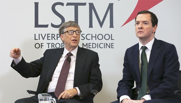 Microsoft co-founder Bill Gates (L) speaks as he sits with Britain's Chancellor George Osborne
