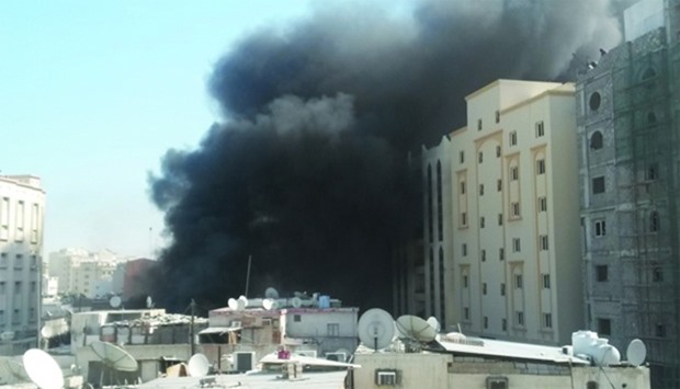 Thick black smoke spewing out of the place where fire broke out in Doha\'s Najma area