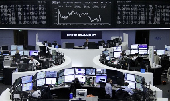 Traders work at the Frankfurt Stock Exchange. The DAX 30 index lost 0.3% yesterday.