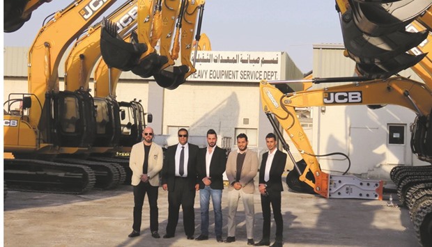 Mannai Heavy Equipment Group and Haffarat Projects officials pose for a photograph.