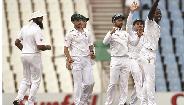 South Africau2019s Kagiso Rabada (right) celebrates with teammates after bowling out Englandu2019s Nick Compton on day four of the fourth Test at Centurion yesterday. (Reuters)