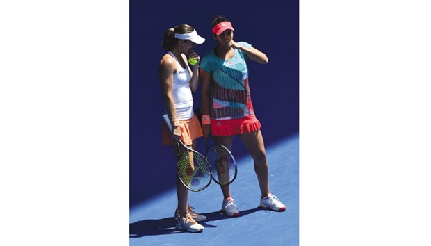 Indiau2019s Sania Mirza (R) and Switzerlandu2019s Martina Hingis speak between points during their womenu2019s doubles match against Germanyu2019s Anna-Lena Groenefeld and Coco Vandeweghe of the US on day nine of the Australian Open in Melbourne yesterday. (AFP)
