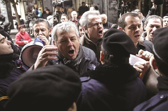 Workers at state hospitals shout slogans during a demonstration outside the Finance ministry in Athens.