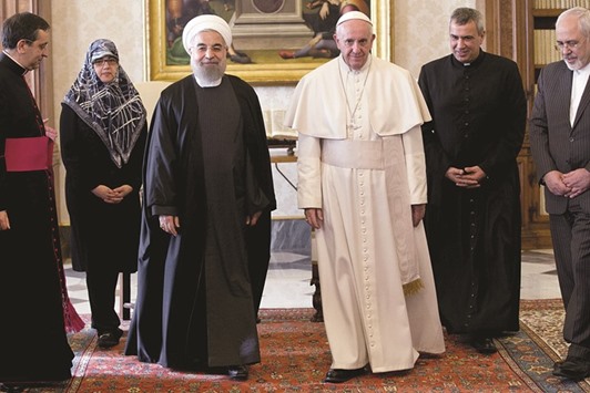 Iran President Hassan Rouhani walks with Pope Francis at the Vatican yesterday.