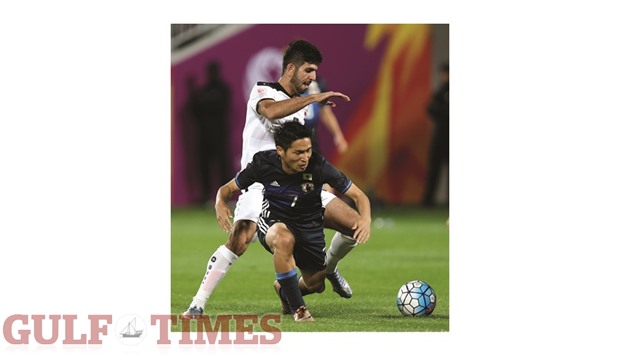 Japanu2019s Riki Harakawa (foreground) is tackled by an Iraqi player during their AFC U23 Championship semi-final match at Abdullah Bin Khalifa Stadium in Doha yesterday. PICTURE: Anas Khalid