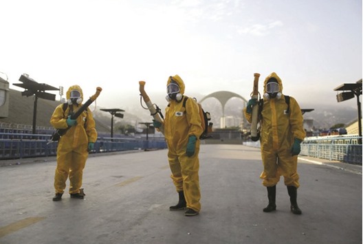 Municipal workers prepare to spray insecticide at Sambodrome in Rio de Janeiro, Brazil, yesterday.