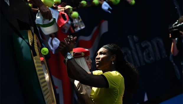 Serena Williams of the US signs autographs after victory during her women's singles match against Russia's Maria Sharapova on day nine of the 2016 Australian Open tennis tournament in Melbourne. AFP